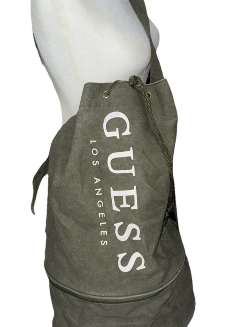 GUESS Olive Canvas Drawstring Sling Duffel Bag with zipper bottom.